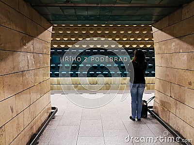 Lonely female waiting for metro in the underground station Editorial Stock Photo