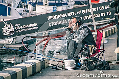 Lonely fisherman on the background of the black sea Editorial Stock Photo