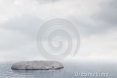 Lonely flat rock in ocean, cloudy sky Stock Photo