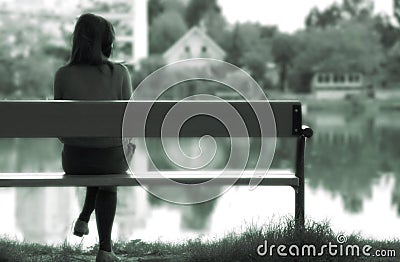 Lonely girl by the lake Stock Photo