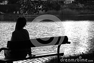 Lonely girl by the lake Stock Photo