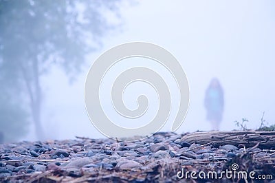 Lonely girl in the mist Stock Photo