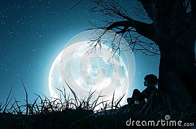Lonely girl sitting alone under the tree and looking to the moon Stock Photo