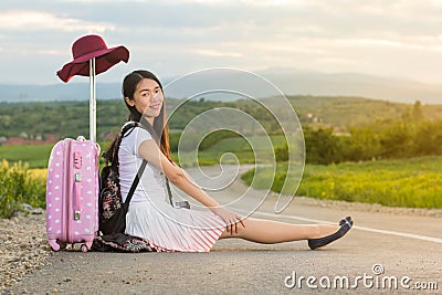 Lonely girl sitting on the road Stock Photo