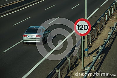 Lonely grey car on highway and SPEED LIMIT sign in Madrid Editorial Stock Photo
