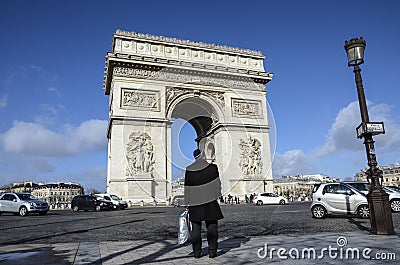 Lonely man looking at Arc de Triomphe, Paris Editorial Stock Photo