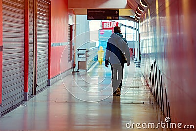 Lonely man walking in a shopping alley awith the shops closed on each side Editorial Stock Photo