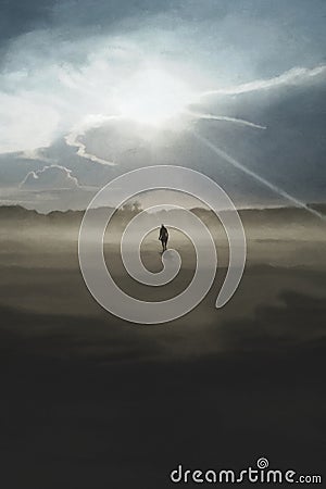 Lonely man walks towards the sun`s rays that illuminate the surrounding landscape Stock Photo