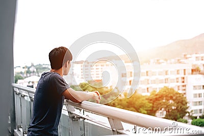Lonely men are looking city view and sunset Stock Photo