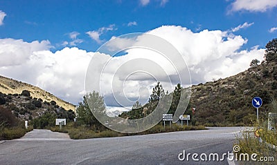 Lonely and moody road with clouds and an interesting light. Mountain road with dramatic colourful sky. Journey, outdoor, travel Stock Photo