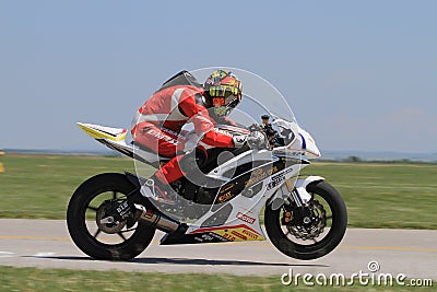 Lonely motorbike racer on rear wheel on the track. Editorial Stock Photo