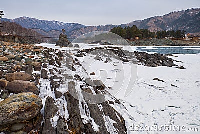 Lonely Pine tree on rock on Altai river Katun in winter. Rocks called Dragon's teeth, Dragon crest, or Sartakpai Arrows Stock Photo