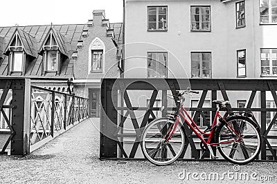 Lonely red bike standing in the typical street in Stockholm Stock Photo