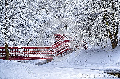 Lonely red bridge dramatic winter snow landscape forest snow on branches vignetting hdr photo Stock Photo