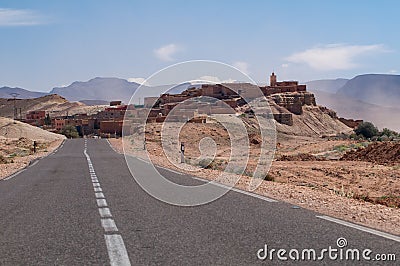 Lonely road to a small village in the desert of Morocco Stock Photo