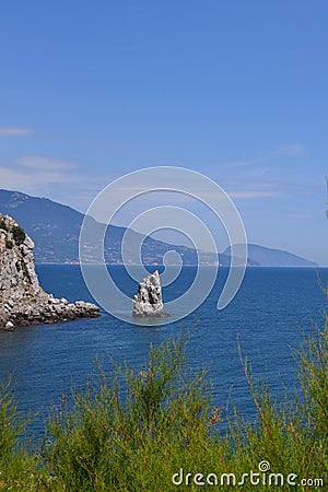 lonely rock sail in the sea Stock Photo