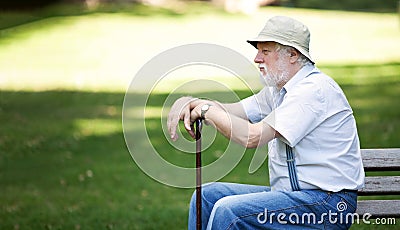 Lonely senior sitting in the park Stock Photo