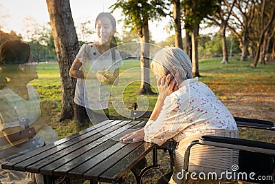 A lonely senior woman is waiting and thinking old memories of her family that will visit her again,depressed elderly people with Stock Photo