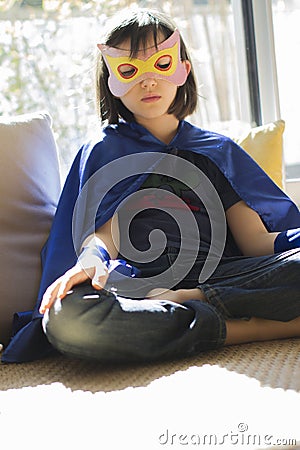 Lonely superhero child finding inner peace into thyself with mindfulness Stock Photo