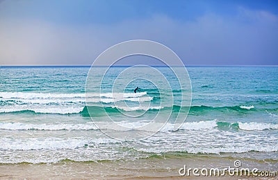 Lonely surfer in the sea Stock Photo