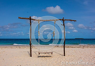 Lonely swing on the beach coast Stock Photo