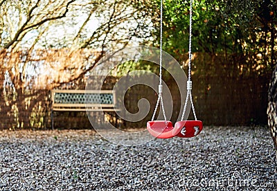 Lonely swings hanging on rope Stock Photo