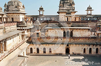 Lonely tourist standing inside courtyard of ancient structure of Jahangir Mahal in India Stock Photo