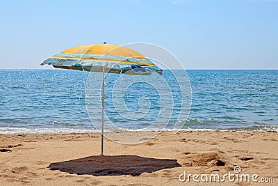 Lonely umbrella on the beach Stock Photo