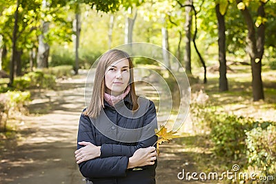 Young woman in park, lonely, thinking about something Stock Photo