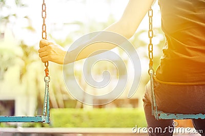 Lonely woman missing her boyfriend while swinging in the park villa in the morning Stock Photo