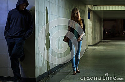 Lonely woman walking at night Stock Photo