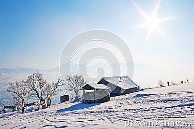 Lonely wooden house in mountains under blue sky Stock Photo