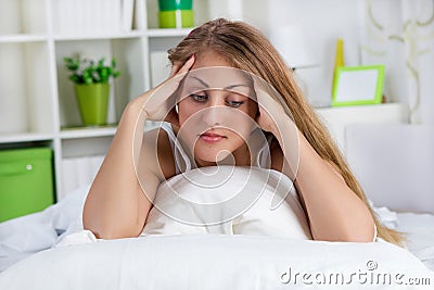 Lonely young woman lying in bed Stock Photo