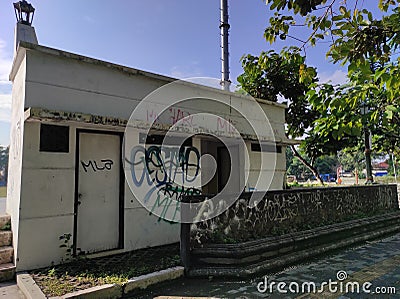 a long-abandoned public bathroom with vandalism paint Stock Photo