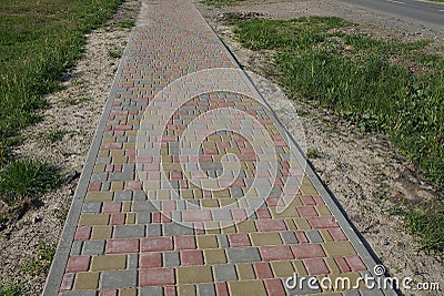 Long alley of colored paving slabs Stock Photo