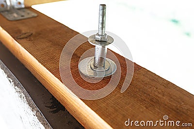 A long anchor bolt for fixing the roof made of trusses. Stock Photo