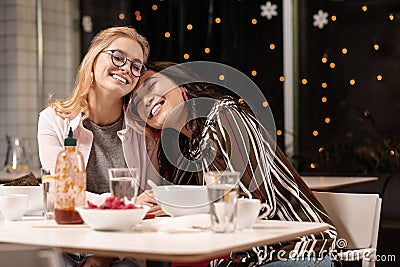 Blonde happy to having meet with her brunette friend after separation. Stock Photo