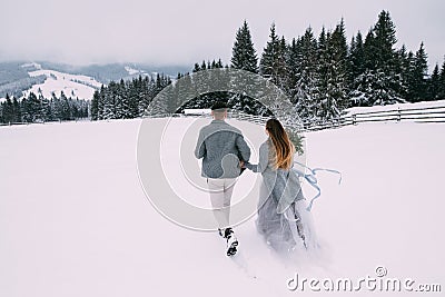 Young pretty pair of lovers. Winter. Date. A pair of lovers on a date in the mountains. Stock Photo