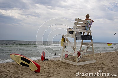 Long Beach Island, New Jersey, USA, 02-25-20 Summer day at the beach Lifeguard and tower with sunny sky with rescue can and fins Editorial Stock Photo