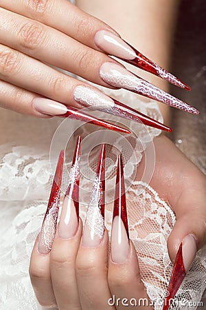 Long beautiful manicure with lace on female fingers. Nails design. Close-up Stock Photo
