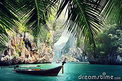 Long boat and rocks on beach in Krabi Stock Photo