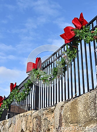 Pine Bough and Red Bows on Wrought Iron Fence 3 Stock Photo