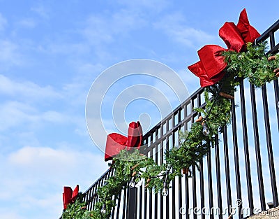 Pine Bough and Red Bows on Wrought Iron Fence 2 Stock Photo