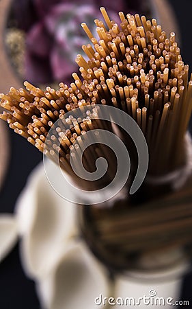 Long brown and one-piece pasta. Closed brown pasta from close and standing view. Stock Photo