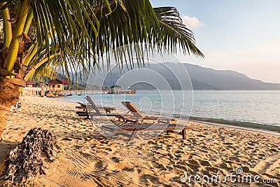 Long chairs on a beach in Pulau Tioman, Malaysia Stock Photo