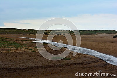 Long coastal stream at the beach, Northern Sea, Holkham beach, United Kingdom Stock Photo