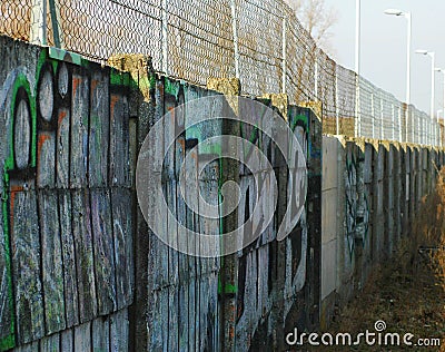 Long concrete wall with grafities. Stock Photo