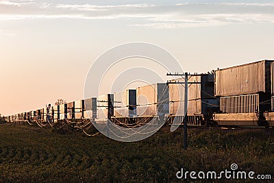 Long Container Train at Sunrise on Canadian Prairie Stock Photo