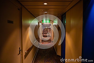 Long corridor of cruise ship, yellow walls and blue doors Stock Photo