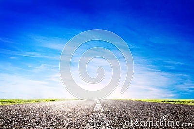 Long empty asphalt road, highway towards sun Stock Photo